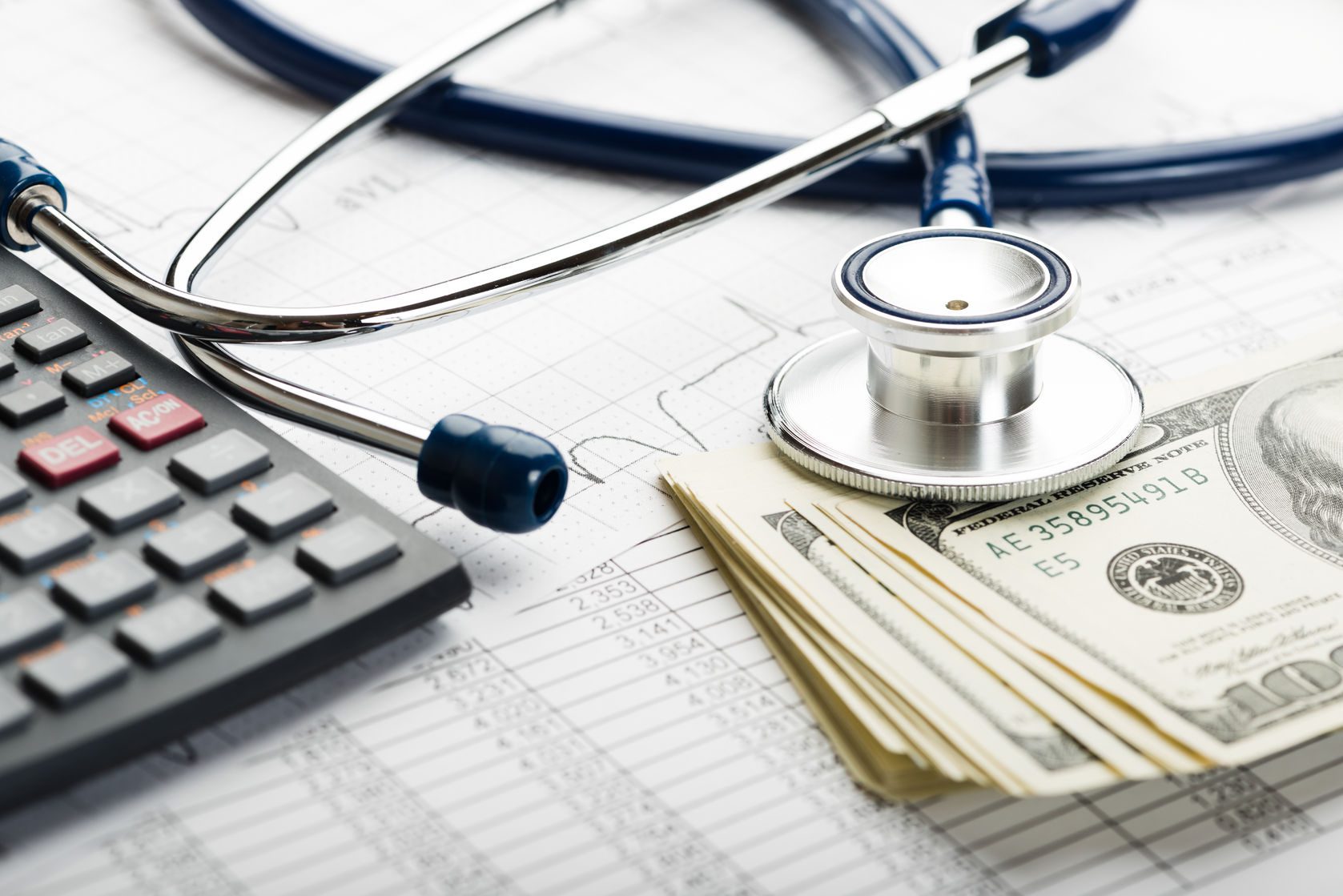 health care costs. stethoscope and calculator symbol for health care costs or medical insurance